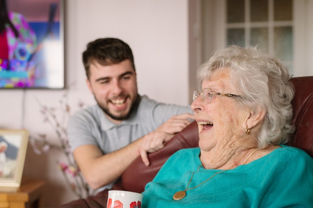 Male Carer & female client laughing