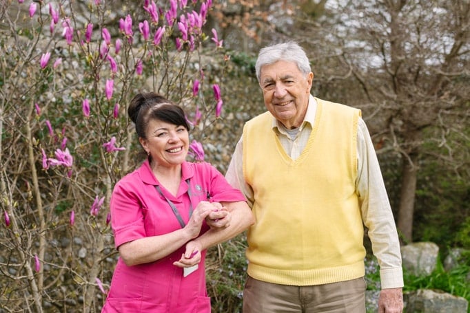 Female Home Carer & male client outside