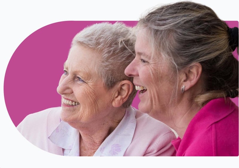 a carer and a client who receives dementia home care smiling 