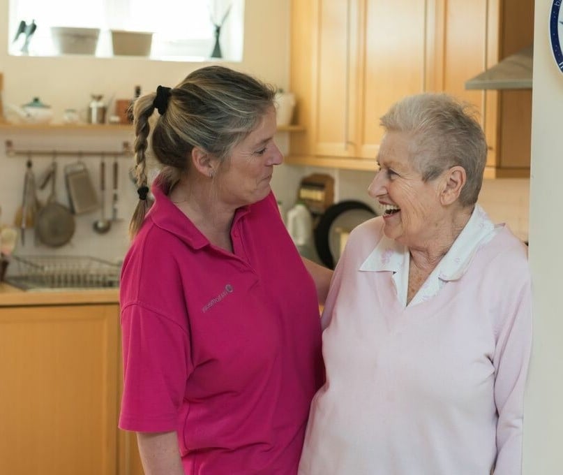 Elderly client with Care Worker in kitchen