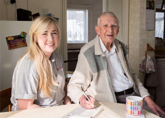 A smiling carer with a client after starting a Care Worker job